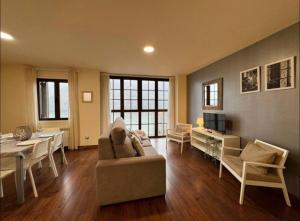 a living room with a couch and a table at CASA PIXURRI en Lanuza compuesta de 5 apartamentos turísticos en casona pirenaica, a 10 minutos de las ESTACIONES de ESQUÍ de FORMIGAL-PANTICOSA in Lanuza