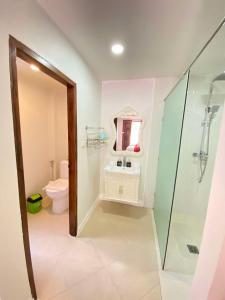 a bathroom with a toilet and a sink and a shower at Luang Prabang Golden Lotus Villa River View in Luang Prabang