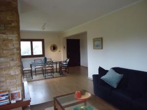 a living room with a couch and a table at Elaionas in Ierissos