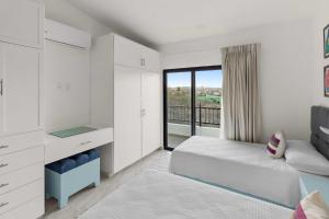 Ένα ή περισσότερα κρεβάτια σε δωμάτιο στο Collection O Morgan City Center, Los Cabos +71 φωτογραφίες