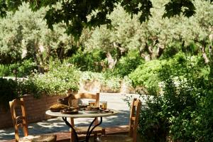 a table with food on it in a garden at The Westin Resort, Costa Navarino in Romanu