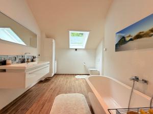 a bathroom with a tub and a sink at Casa Braun in Bodman-Ludwigshafen +68 photos