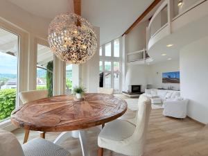 a dining room with a wooden table and chairs at Casa Braun in Bodman-Ludwigshafen