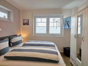a bedroom with a bed and a window at Ferienhaus Xena in Biendorf