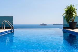 a swimming pool with a view of the ocean at Villa turquoise in Kalkan