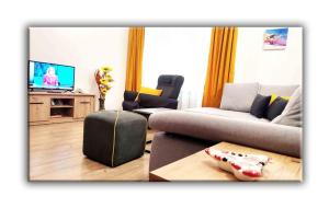 a living room with a couch and a tv at T&M Stay Pamporovo in Pamporovo +52 photos