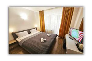 a bedroom with a bed with two teddy bears on it at T&M Stay Pamporovo in Pamporovo