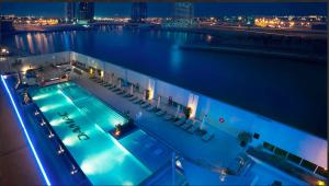 a swimming pool on a cruise ship at night at Cozy Canal View Studio in Dubai