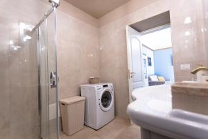 a bathroom with a washing machine and a sink at Old House - Historic Beauty Central Home, Otranto in Otranto