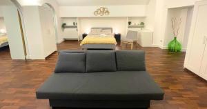 a room with two beds and a couch in it at Antica Muraglia Apartments in Molfetta