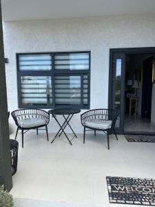 two benches and a table on a patio at Villa Christine in Ocho Rios