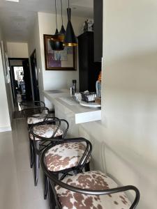 two chairs sitting in a kitchen with a counter at Villa Christine in Ocho Rios