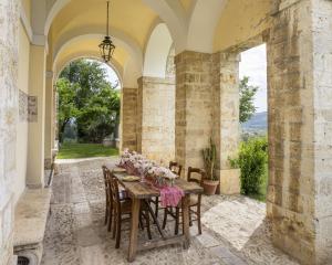 a dining room with a table with flowers on it at Entire Private Floor in an 1800s Frescoed Villa with Historic Park - Villa Mastrangelo in Colli del Tronto +38 photos