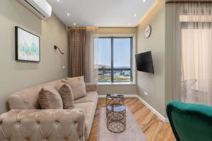 a living room with a couch and a tv at XIO Apartments in Bar