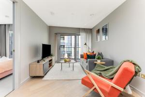 a living room with a couch and a tv at ShySuite 1BED in London