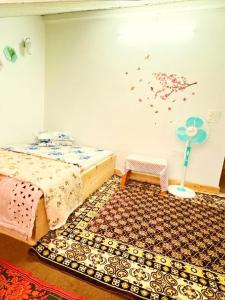 a bedroom with two beds and a rug at Nehal Royal Homestay in Kalimpong +3 photos