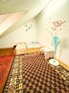 a bedroom with a bed and a fan on the floor at Nehal Royal Homestay in Kalimpong