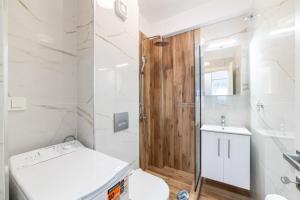 a bathroom with a toilet and a shower and a sink at Erato Residential Complex in Ofrínion +66 photos