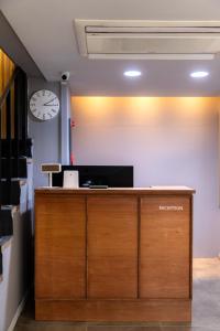 an office with a reception desk with a clock on the wall at About Stay Seoul in Seoul