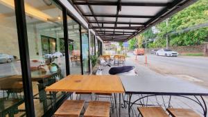 a restaurant with a table and benches on a street at Jonah Hotel in Chiang Mai
