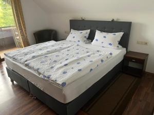a bed in a bedroom with at Gasthof ALTE POST in Waldachtal