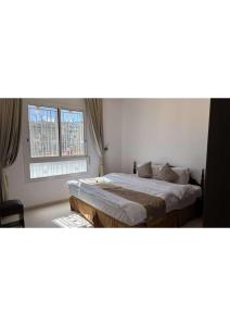 a bedroom with two beds and a window at abha condo in Abha