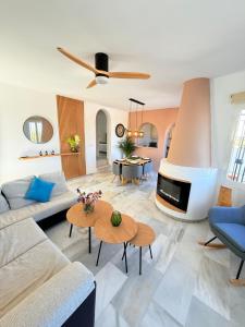a living room with a couch and a fireplace at Casa Oasis in Nerja