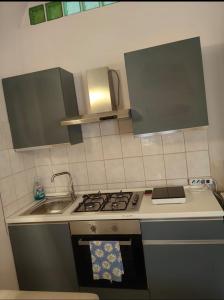 a kitchen with a stove and a sink at Sweet home Lago di Garda in Prevalle