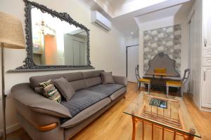 a living room with a couch and a mirror at Sea Pearl Apartments in Vlorë