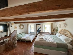 a bedroom with two beds and a television in it at Golfo Paradiso Home in Sori