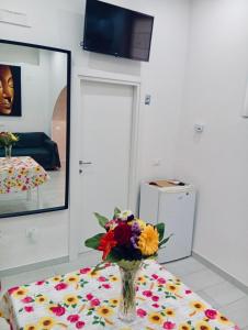 a vase of flowers on a table in a room at Casa Francesca in Mercato San Severino