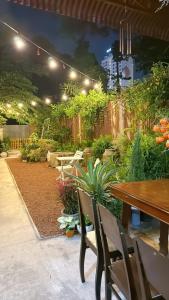 a patio with a table and chairs and plants at North House in Ấp Bình Trung