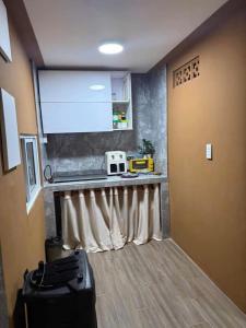 a room with a kitchen with a counter and a window at North House in Ấp Bình Trung
