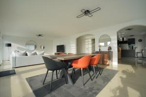 a living room with a dining room table and chairs at Montreux panoramic view with garden in Montreux