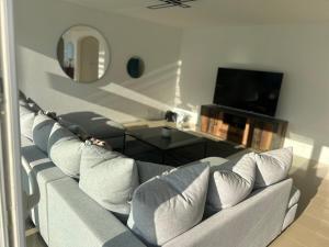 a living room with a couch and a tv at Montreux panoramic view with garden in Montreux
