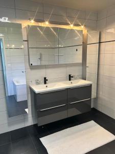 a bathroom with a sink and a mirror at Montreux panoramic view with garden in Montreux +51 photos