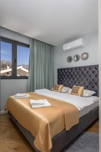 Postel nebo postele na pokoji v ubytování XIO Apartments