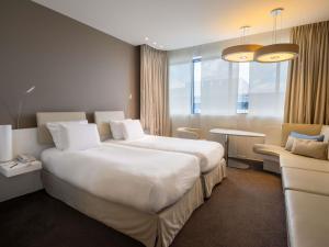 Voodi või voodid majutusasutuse Pullman Brussels Centre Midi toas