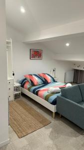 a bedroom with a large bed and a couch at Cozy studio with terrace and view Collobrières in Collobrières