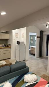 a living room with a couch and a refrigerator at Cozy studio with terrace and view Collobrières in Collobrières