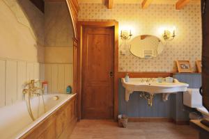a bathroom with a tub and a sink and a mirror at Chalet avec charme et vue à Crans-Montana in Crans-Montana +23 photos