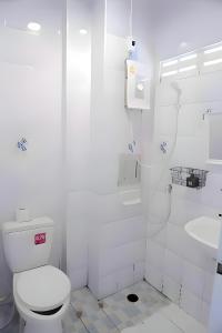 a white bathroom with a toilet and a sink at BAO Patong Beach Phuket - เบา ป่าตอง in Patong Beach