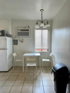 a kitchen with a table and chairs and a refrigerator at Riverton Place NoHo in Los Angeles