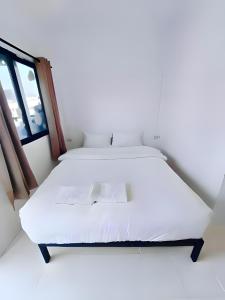 a white bed in a room with a window at BAO Patong Beach Phuket - เบา ป่าตอง in Patong Beach +18 photos