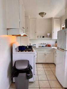 a kitchen with white cabinets and a white stove top oven at Riverton Place NoHo in Los Angeles