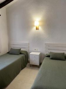 מיטה או מיטות בחדר ב-Apartamentos LLorca