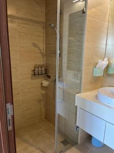 a bathroom with a shower and a sink at Sea Moon full Apartment in Ha Long +24 photos