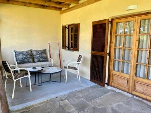 a patio with a couch and chairs and a table at Reef in Afitos