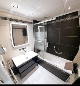 a bathroom with a sink and a shower with a mirror at Estudio I vistas mar, cerca tren y Malaga in Torremolinos +38 photos