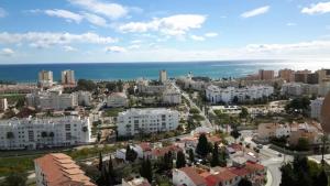 an aerial view of a city with buildings and the ocean at Estudio I vistas mar, cerca tren y Malaga in Torremolinos